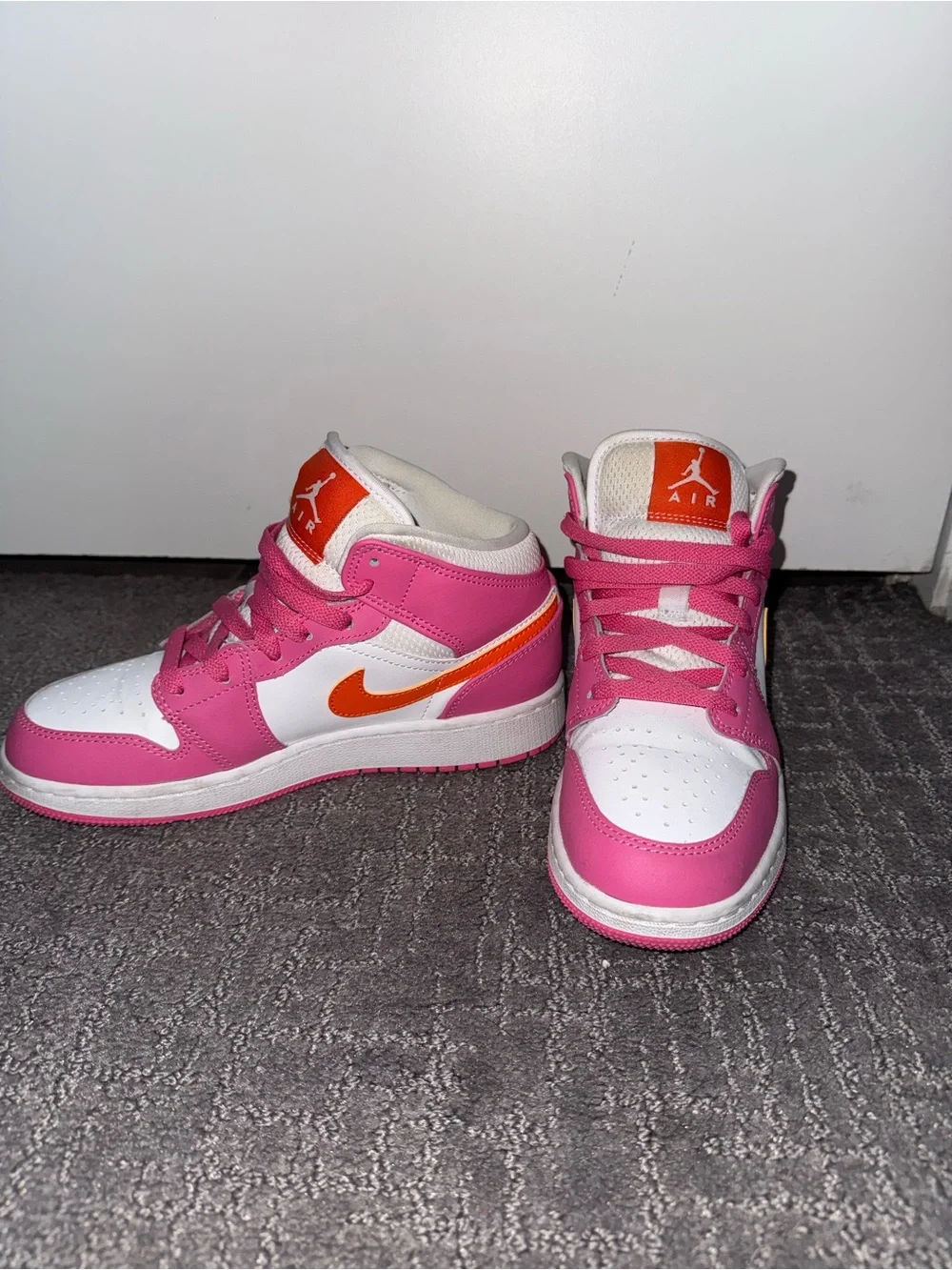 Jordan Pink and White High-Top Sneakers with Orange Tongue Logo
